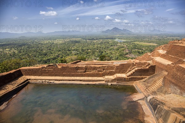 Historic rock fortress with water pool