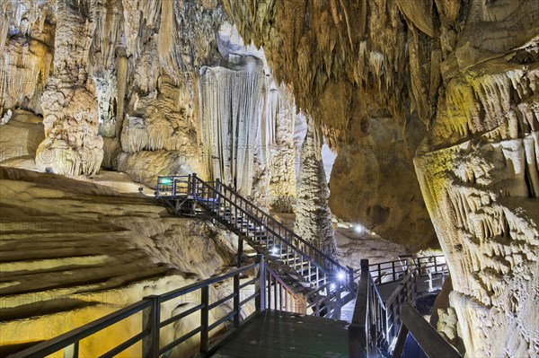 Boardwalk through illuminated dripstone cave