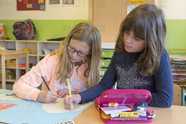 Girls painting in elementary school