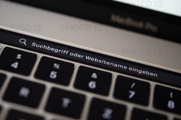 Backlit keyboard and Touch Bar showing search bar