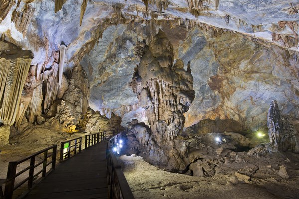 Boardwalk through illuminated dripstone cave