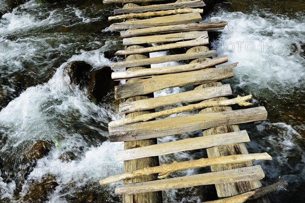 Simple wooden bridge over river