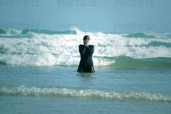 Woman in black dress with mask