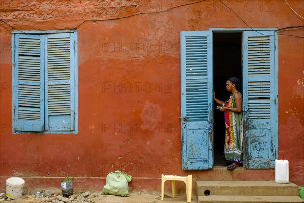 Woman in the door of a colonial building on the Isle de Goree