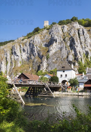 Old wooden bridge over side arm of the Altmuhl River with Randeck Castle