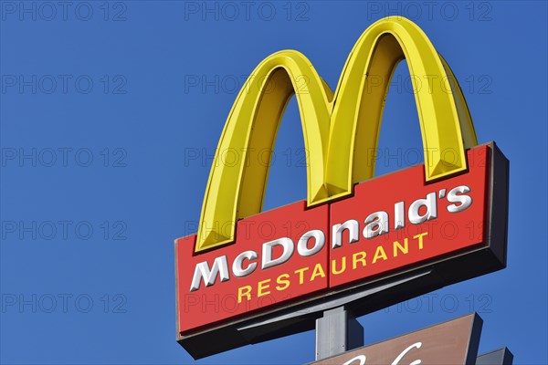 McDonalds sign against a blue sky