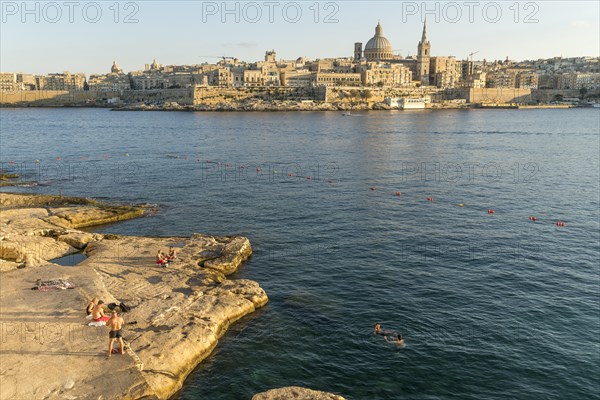 Bathing place on the rocks of Tigne Seafront with city view