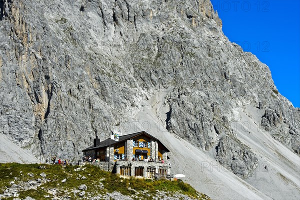 Carschinahutte in front of rock wall of Sulzfluh