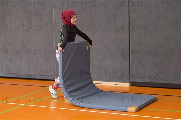 Schoolgirl wearing floor mat