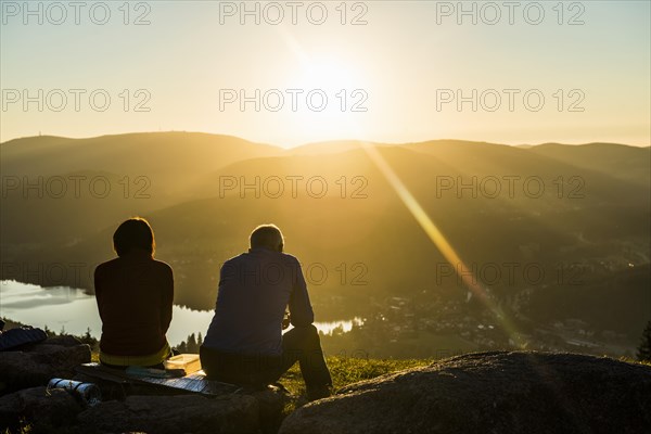 Older couple at Hochfirst with view to Titisee and Feldberg at sunset