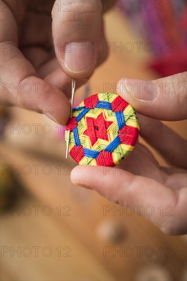 Button maker stitching and wrapping green