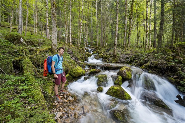 Young man by a creek