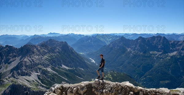 Hiker at the summit of the Hochvogel
