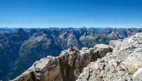 Hiker sits on rocks