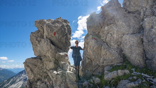 Hiker stands between rocks