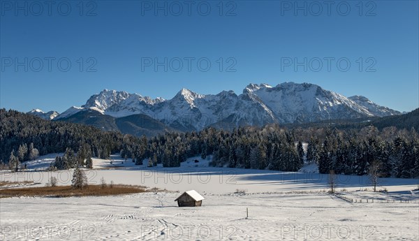 Frozen Lake Geroldsee in winter in front of Karwendel Mountains