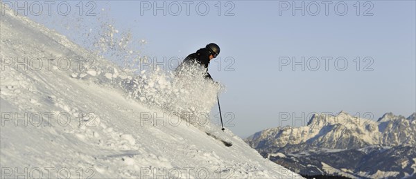 Skier with splashing snow