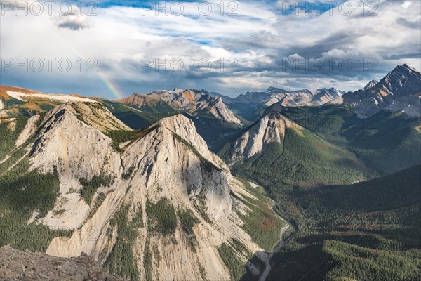 Panoramic view on mountain landscape with rainbow