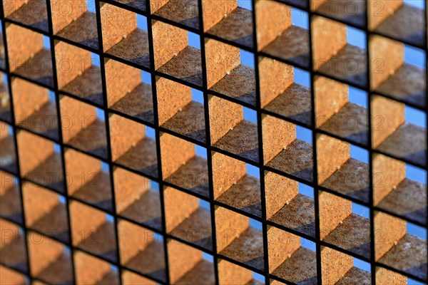 Rusty grid against a blue sky