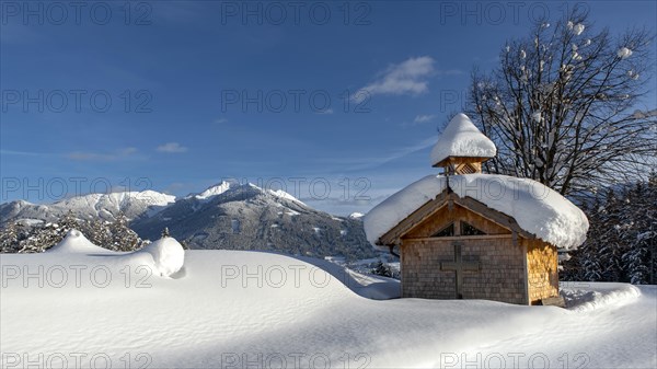 Wooden chapel with snow on Vomperberg