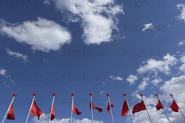 Red flags with red star at the monument of Mao Tse-tung