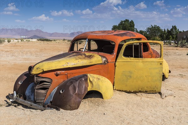 Old car wreck in sand