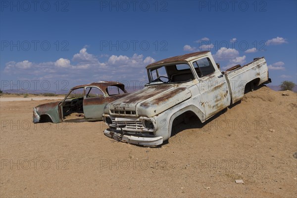 Old car wreck in sand