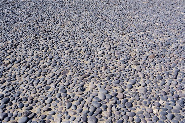 Round black pebbles on the beach