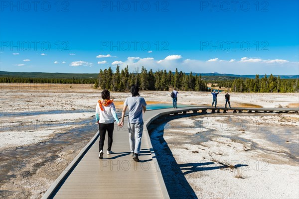 Two tourists on a jetty in the thermal area