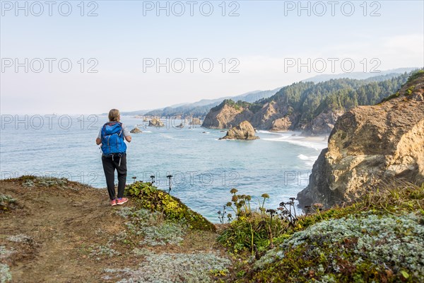 Young woman looking out to sea