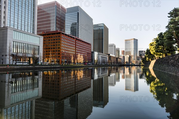 High-rise buildings reflected in a canal