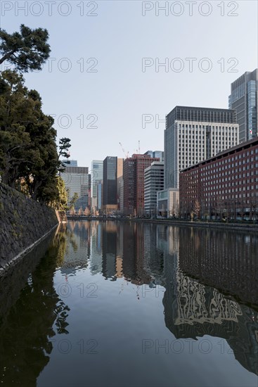 High-rise buildings reflected in a canal