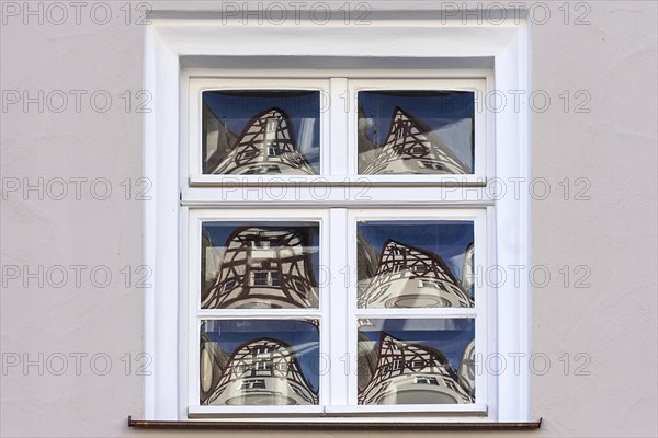 Half-timbered houses reflected in glass windows