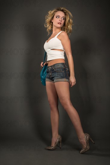 Young woman in hotpants and bag