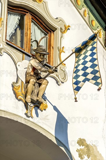 Wooden figure of a boy in leather pants with Bavarian Flag lozenge type