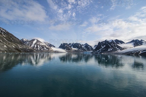 Mountains reflecting in the water in the Magdalenefjorden