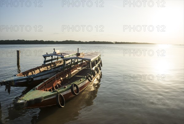 Boats at sunset on the Suriname river near Paramaribo