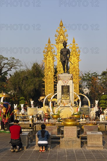 Praying in front of Monument of King Mangrai
