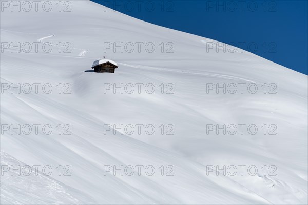 Small mountain hut in winter landscape