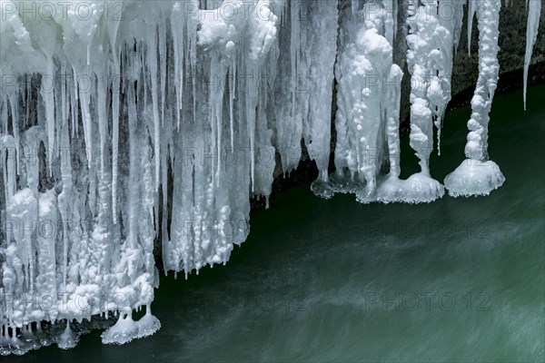 Icicles over running water
