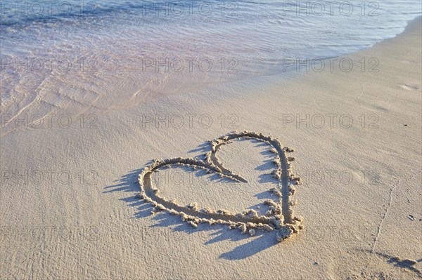 Heart paintet in sand