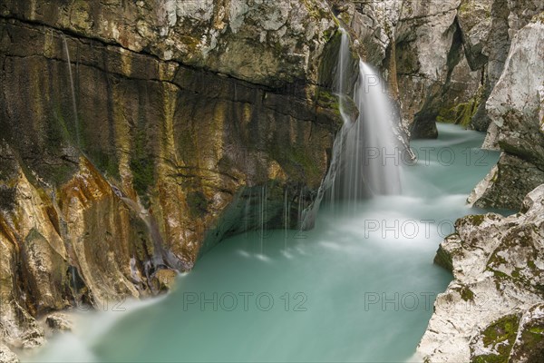 Waterfall on the emerald green wild river Soca