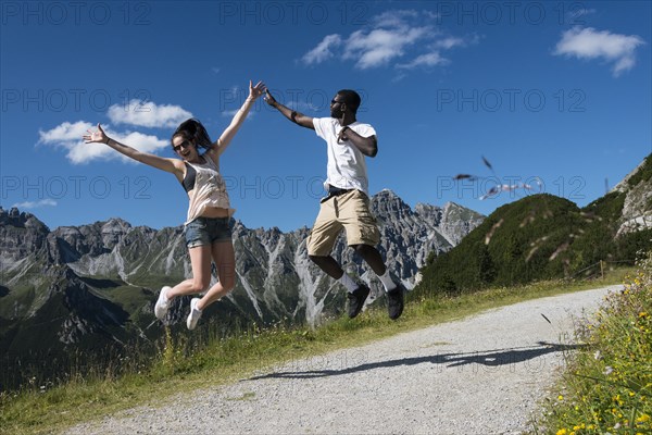 Couple jumping joyfully in the air