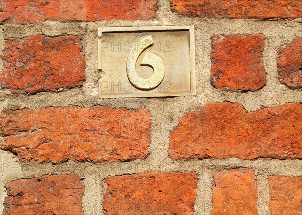Old golden house number plate