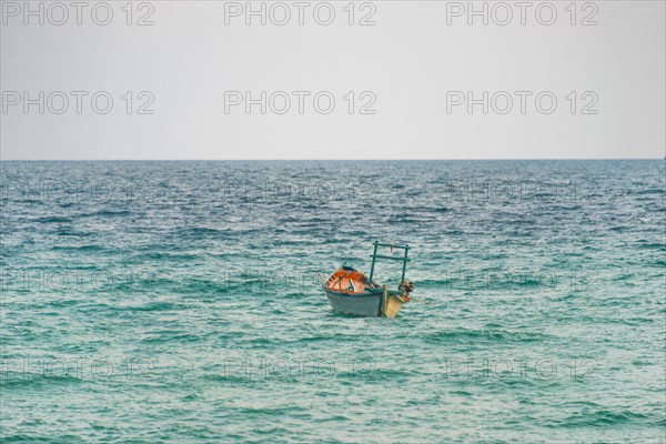 Traditional long-tail boat in turquoise sea