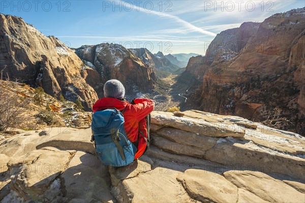 Young woman looking into the distance from Angels Landing to Zion Canyon