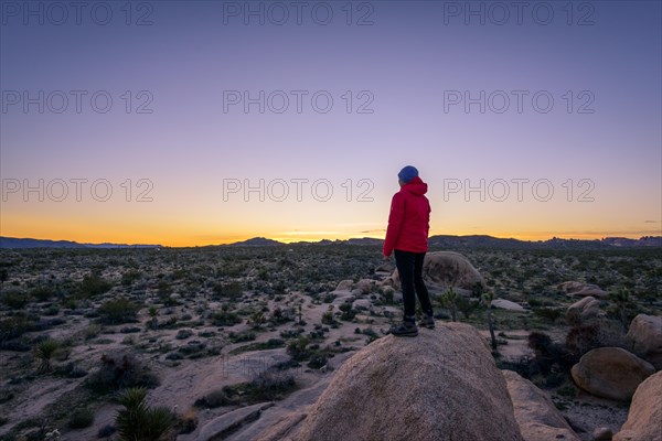 Young woman standing on granite rocks