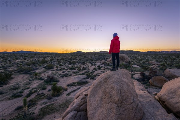 Young woman standing on granite rocks