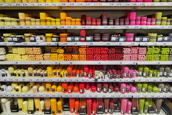Shelves with coloured candles in supermarkets
