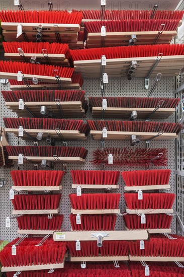 Brooms with plastic bristles in hardware store